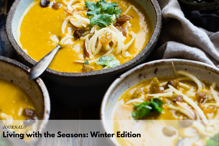Creamy pumpkin soup topped with noodles, raisins, and fresh parsley for a nourishing winter meal