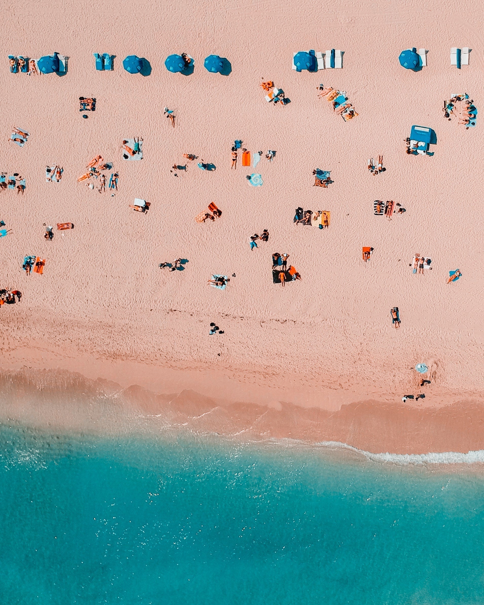 People relaxing on a sunny beach, representing summer wellness, seasonal living, and Traditional Chinese Medicine-inspired self-care, healthy eating, and balance.