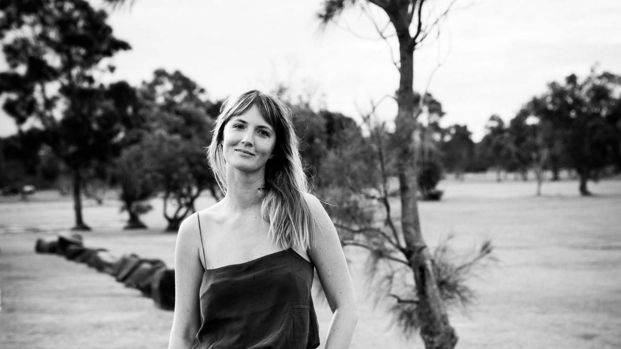 Portrait of Tahnee McCrossin, General Manager of SuperFeast, smiling outdoors in a park for the Women We Love interview.